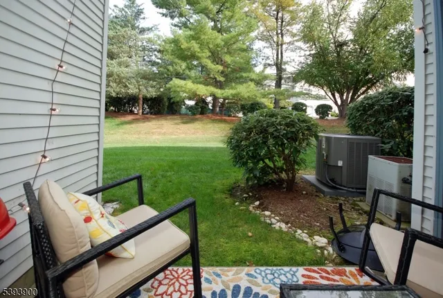a view of backyard with seating space and trees