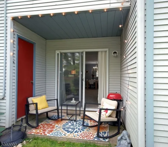 a backyard of a house with table and chairs