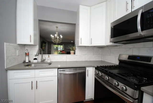 a kitchen with a sink stove and microwave