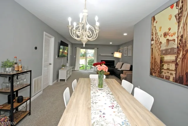 a view of a dining room with furniture and a chandelier