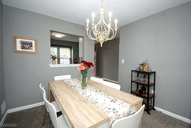 a view of a dining room with furniture and chandelier
