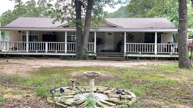 a view of a house with backyard and porch