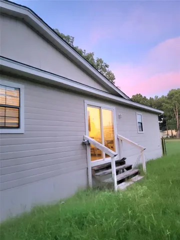a backyard of a house with table and chairs
