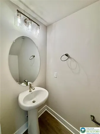 a bathroom with a sink mirror and toilet