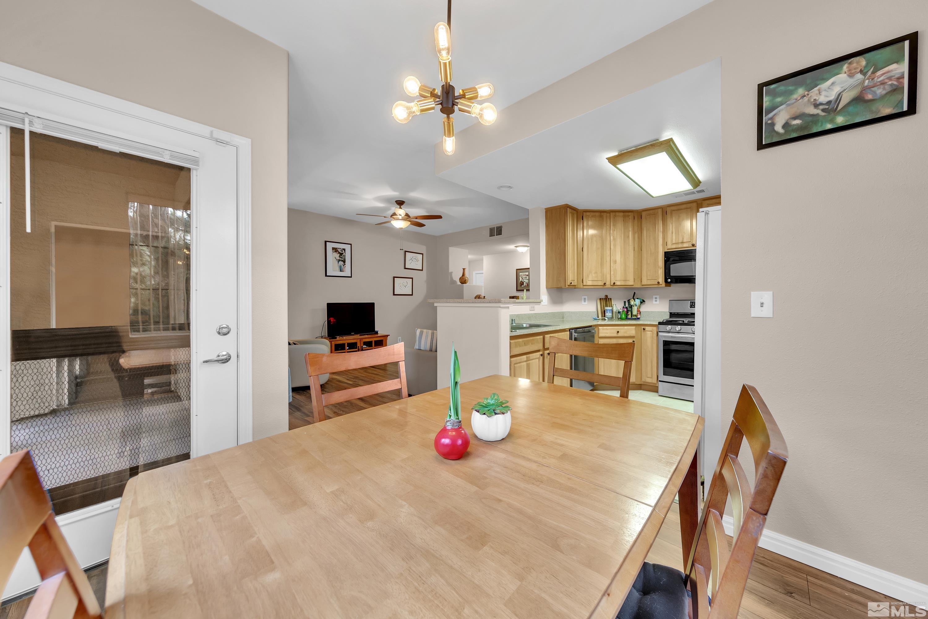 900 South Meadows Parkway, Unit 111 Reno, NV 89521 - Photo 15 of 35 a living room with stainless steel appliances kitchen island furniture and a view of kitchen