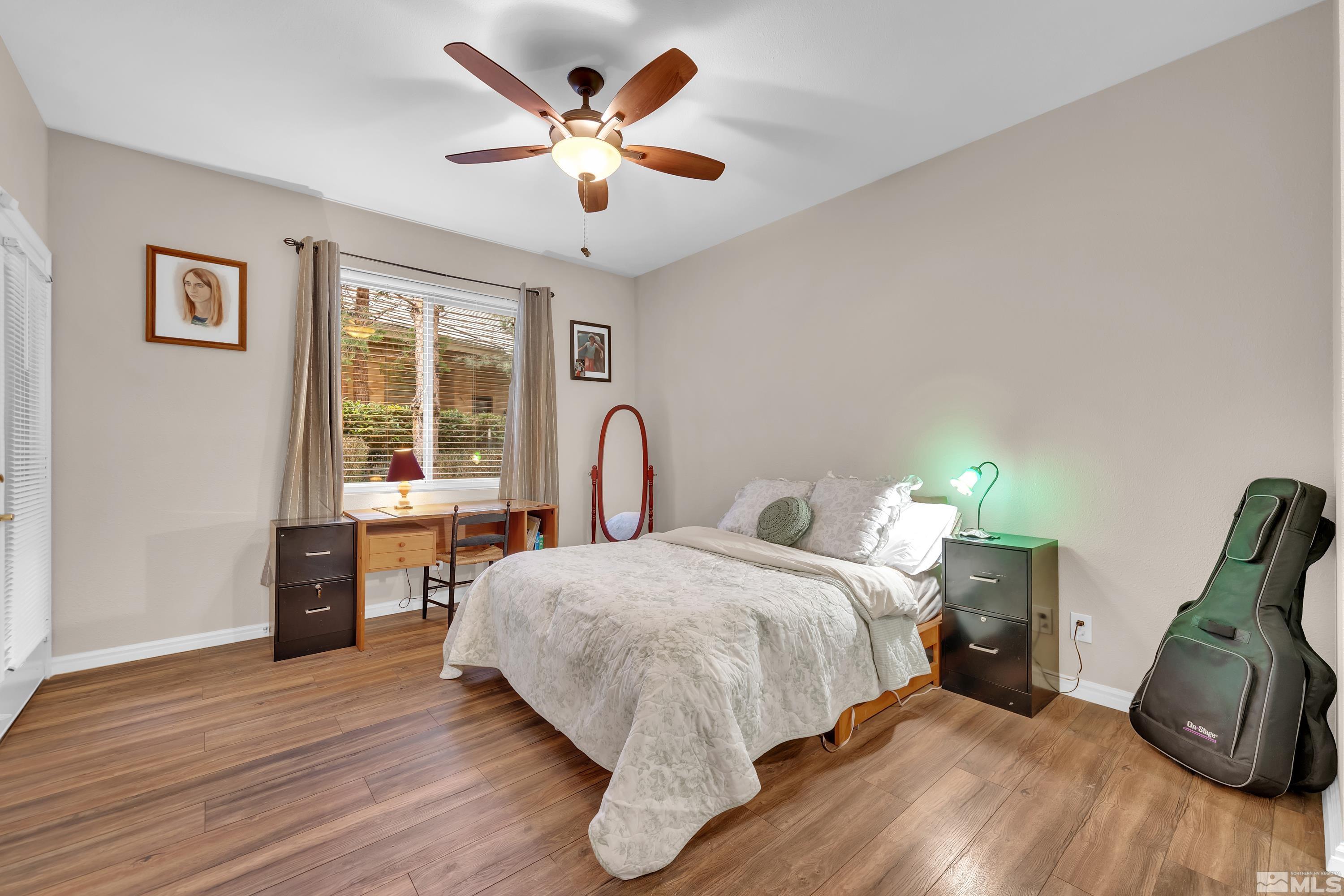 900 South Meadows Parkway, Unit 111 Reno, NV 89521 - Photo 16 of 35 a bed room with a bed and a chair
