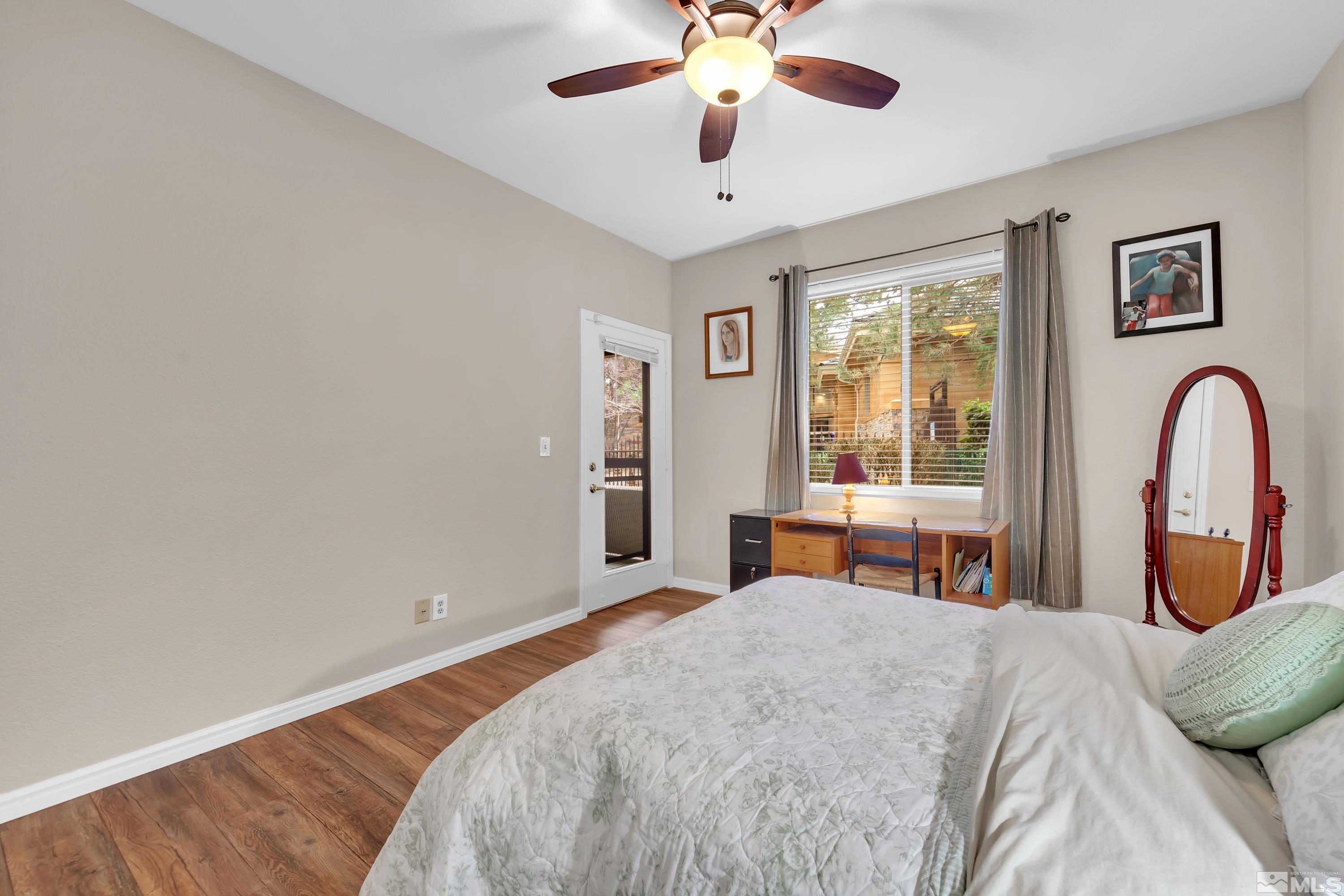 900 South Meadows Parkway, Unit 111 Reno, NV 89521 - Photo 17 of 35 a bedroom with a bed and a large window