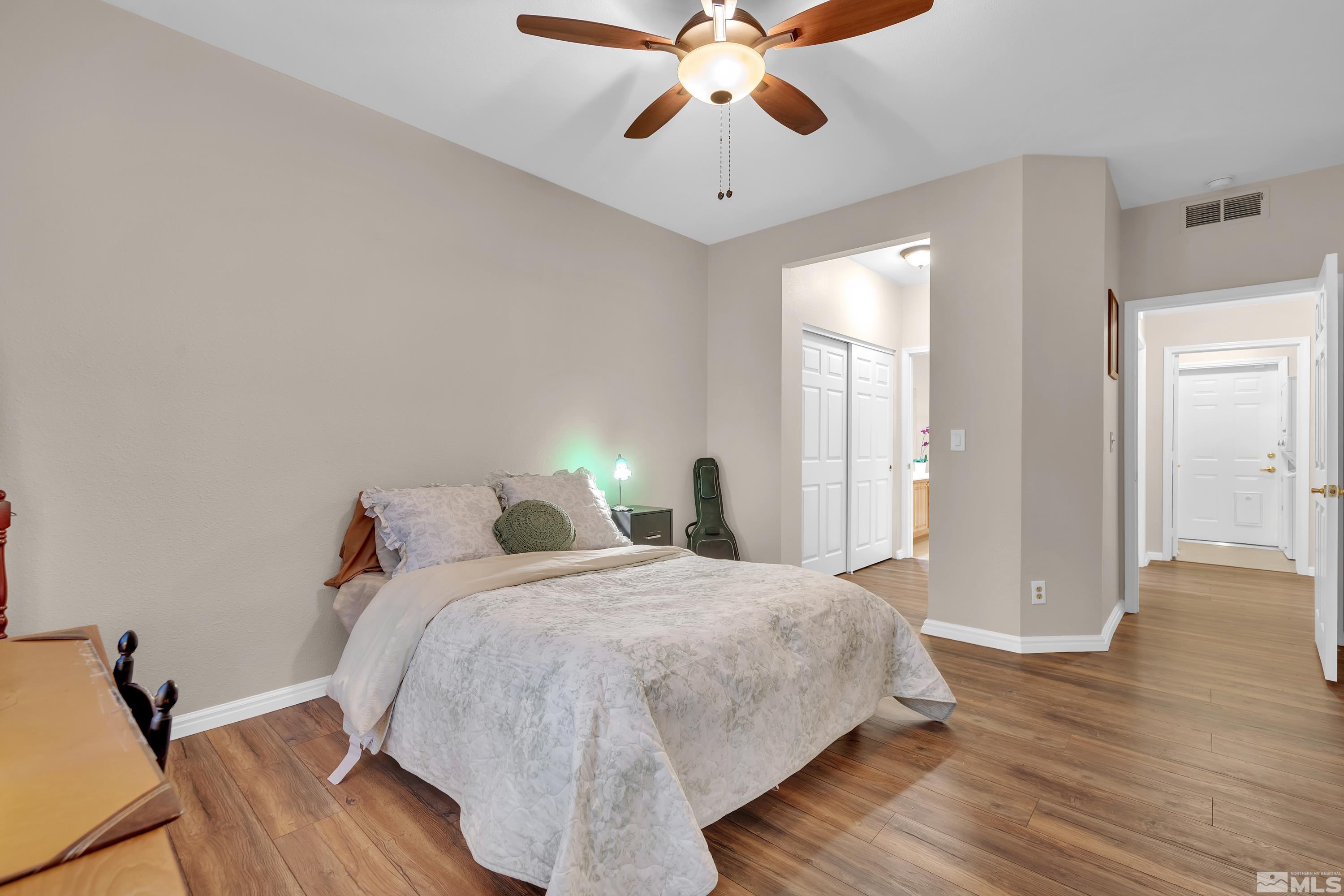 900 South Meadows Parkway, Unit 111 Reno, NV 89521 - Photo 18 of 35 a bedroom with bed and wooden floor