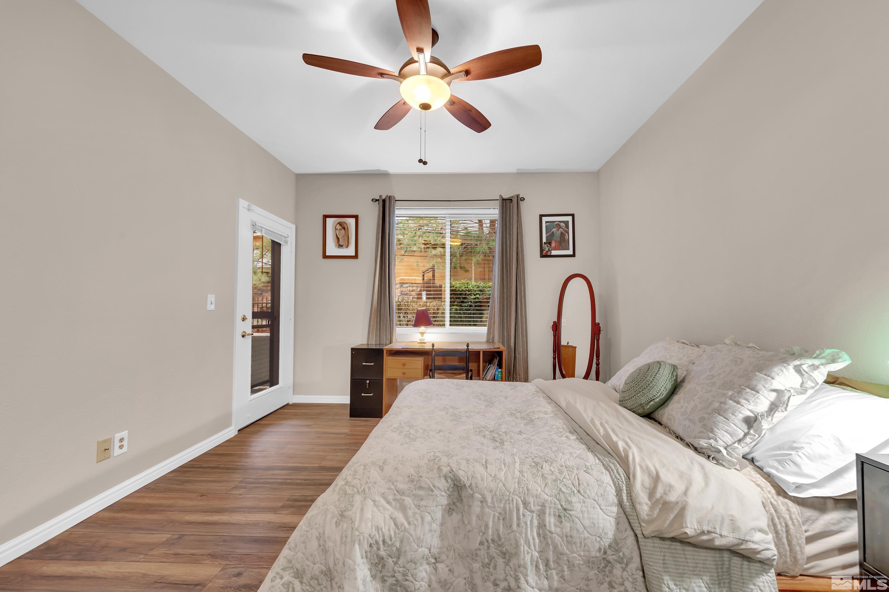 900 South Meadows Parkway, Unit 111 Reno, NV 89521 - Photo 19 of 35 a bedroom with a large bed and a chandelier