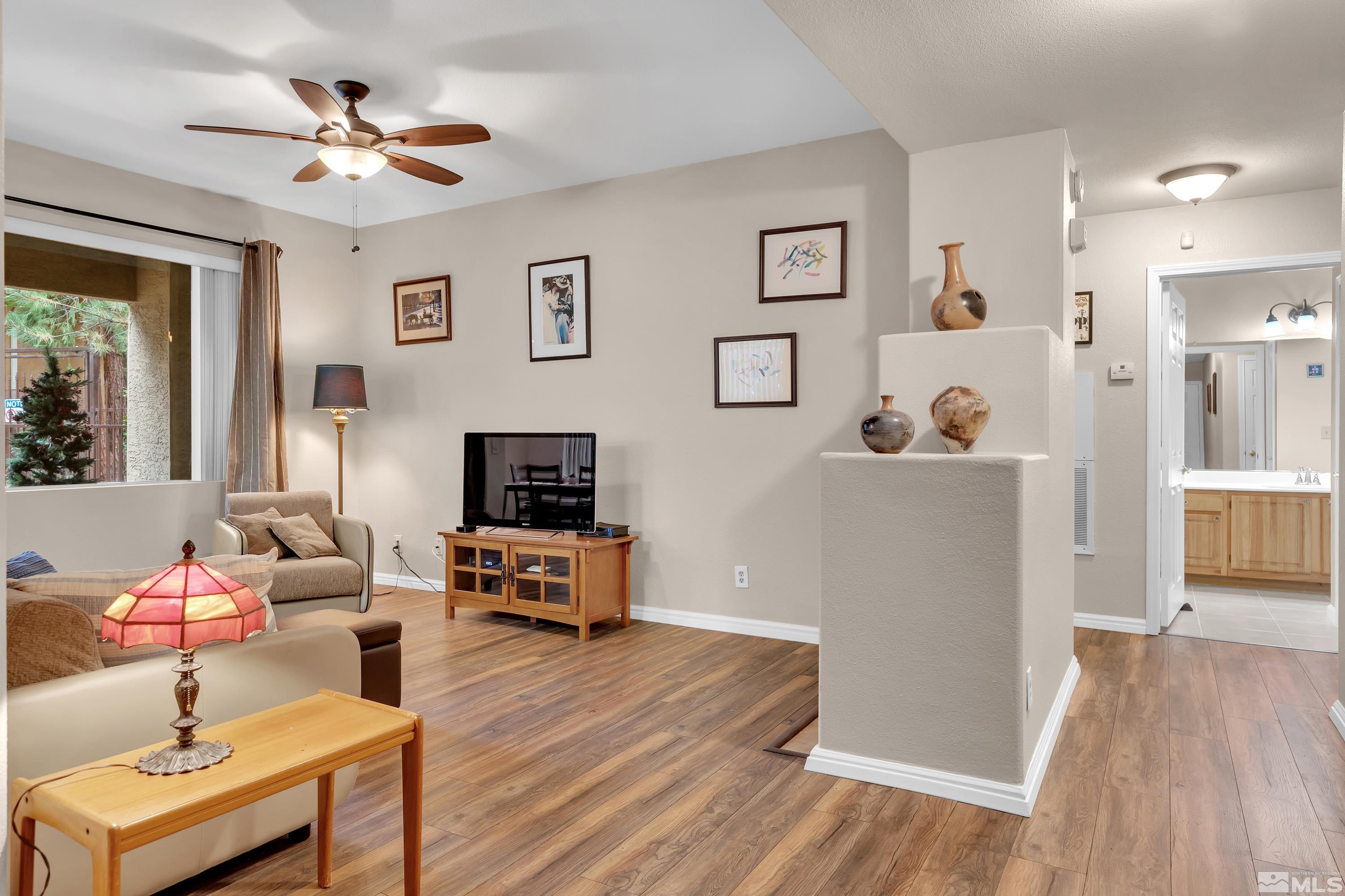 900 South Meadows Parkway, Unit 111 Reno, NV 89521 - Photo 2 of 35 a living room with furniture and a flat screen tv