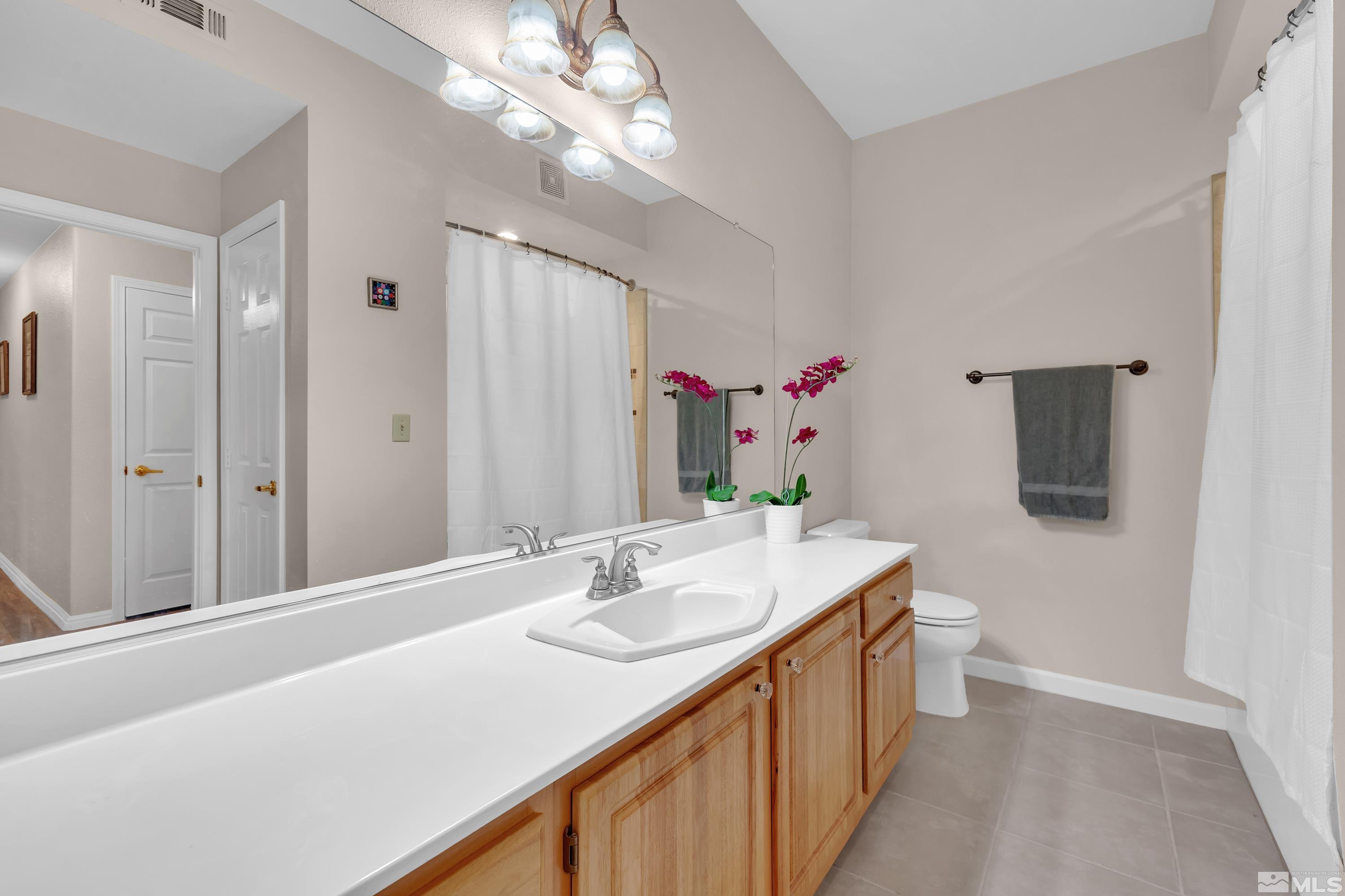 900 South Meadows Parkway, Unit 111 Reno, NV 89521 - Photo 21 of 35 a bathroom with a sink a vanity and a mirror
