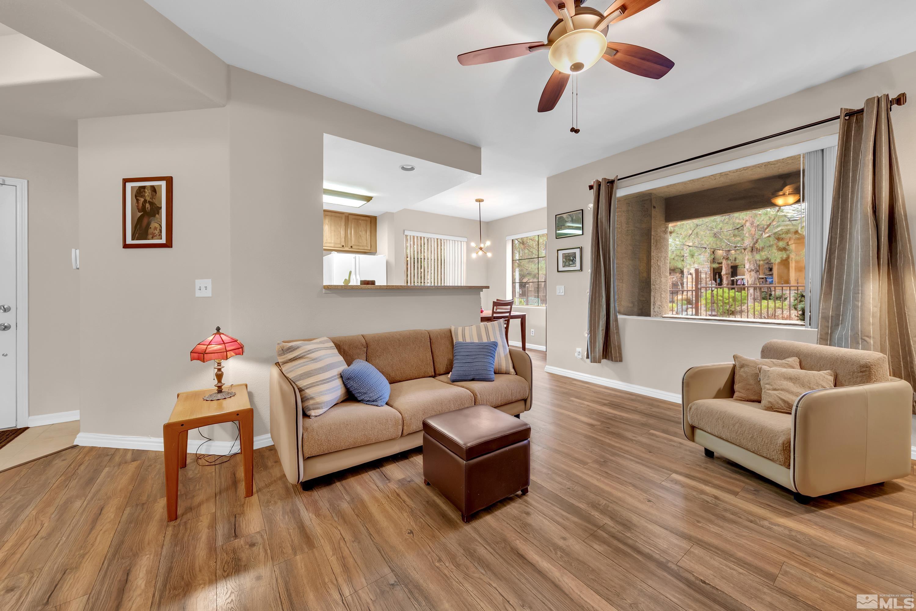 900 South Meadows Parkway, Unit 111 Reno, NV 89521 - Photo 4 of 35 a living room with furniture and a wooden floor