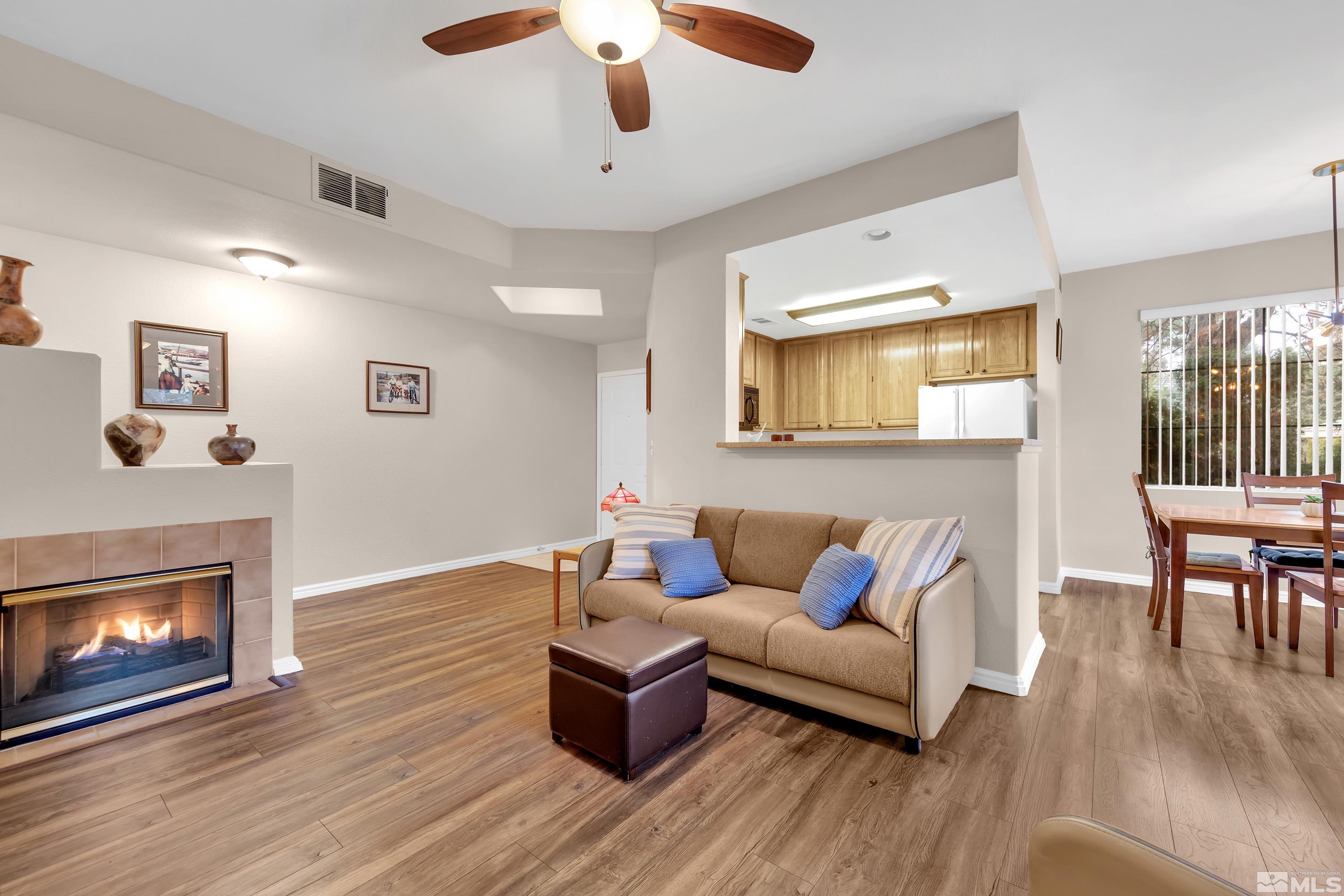 900 South Meadows Parkway, Unit 111 Reno, NV 89521 - Photo 5 of 35 a living room with furniture and a fireplace