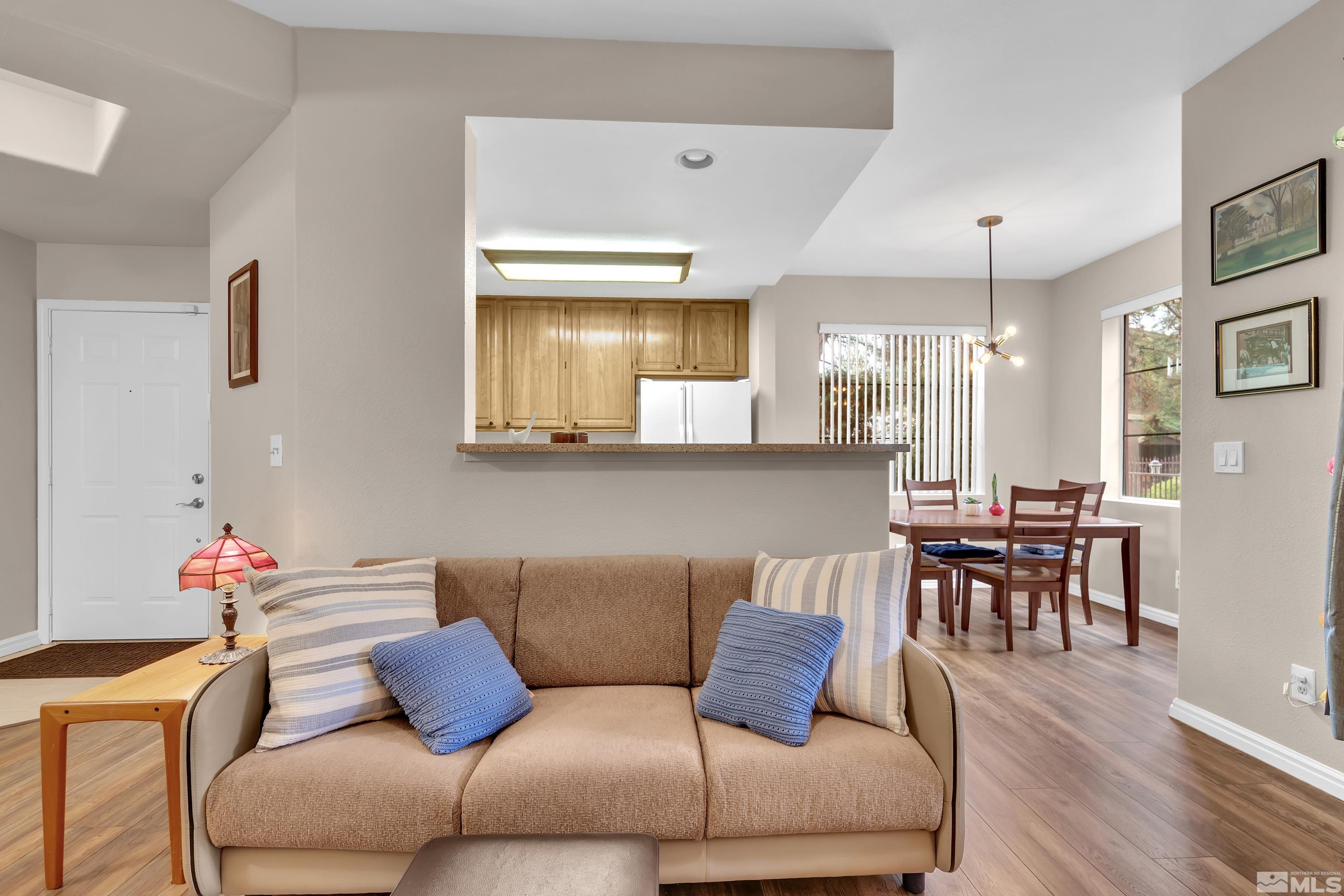 900 South Meadows Parkway, Unit 111 Reno, NV 89521 - Photo 6 of 35 a living room with furniture kitchen view and a dining table