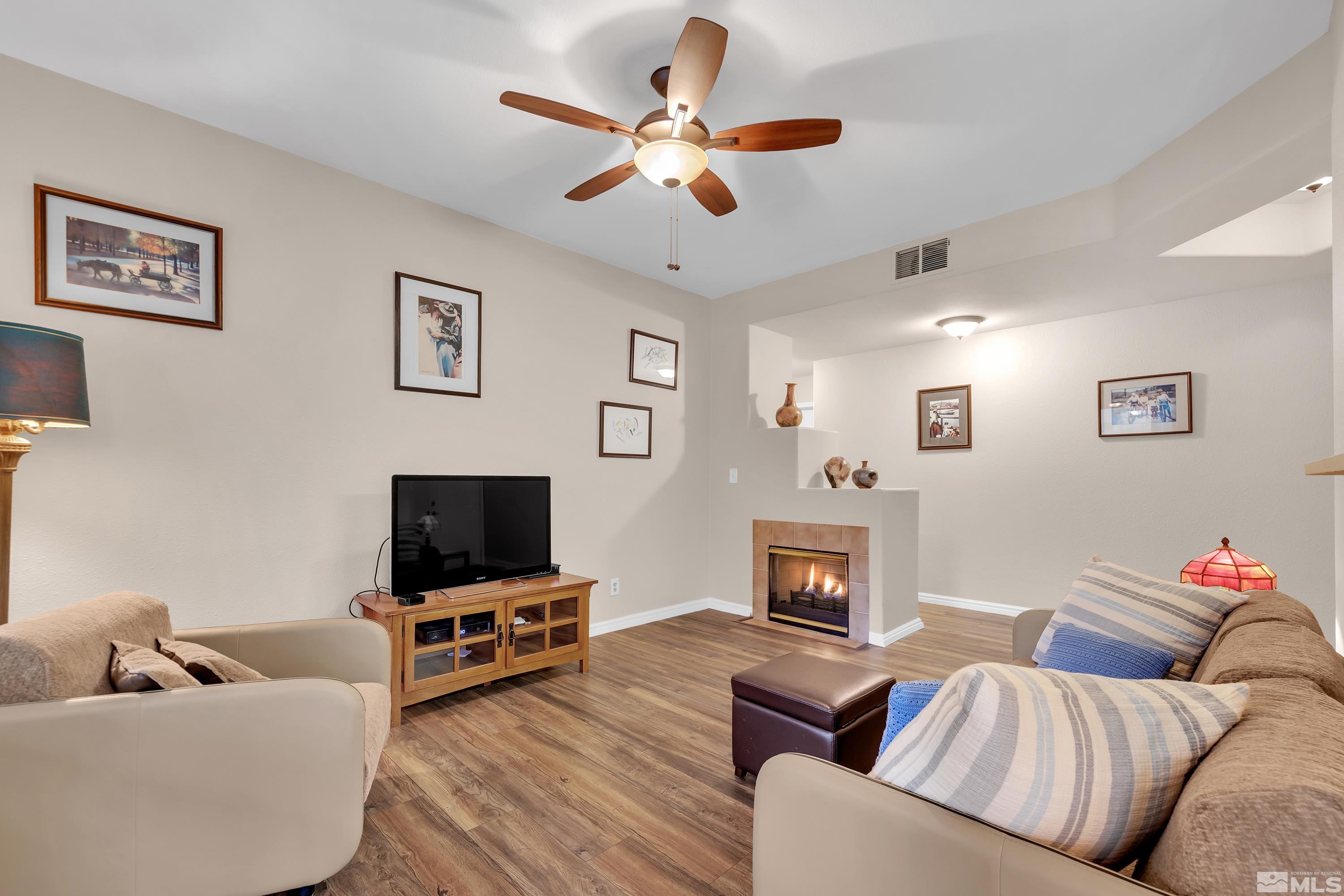 900 South Meadows Parkway, Unit 111 Reno, NV 89521 - Photo 7 of 35 a living room with furniture flat screen tv and a fireplace