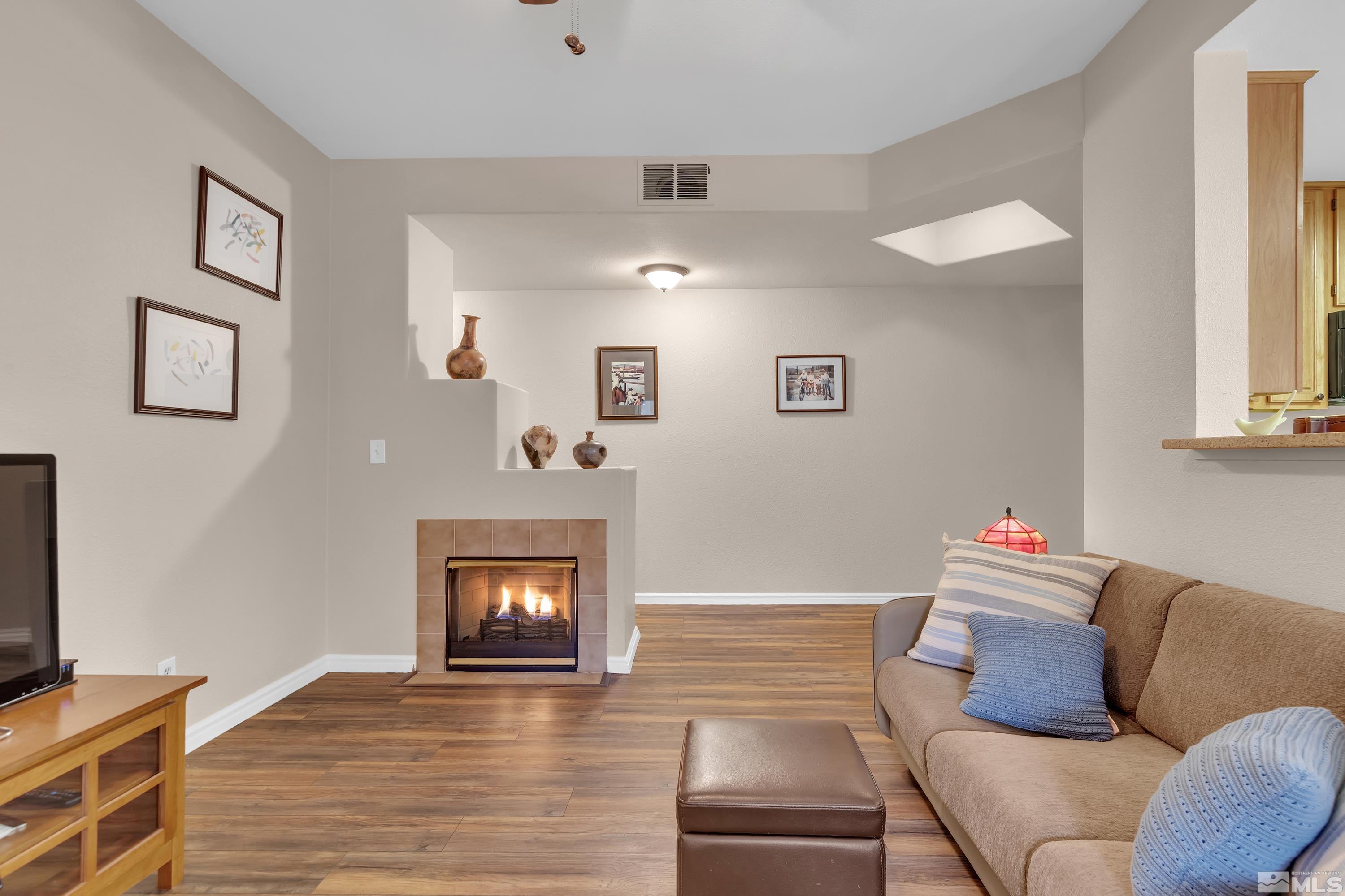 900 South Meadows Parkway, Unit 111 Reno, NV 89521 - Photo 8 of 35 a living room with furniture and a flat screen tv
