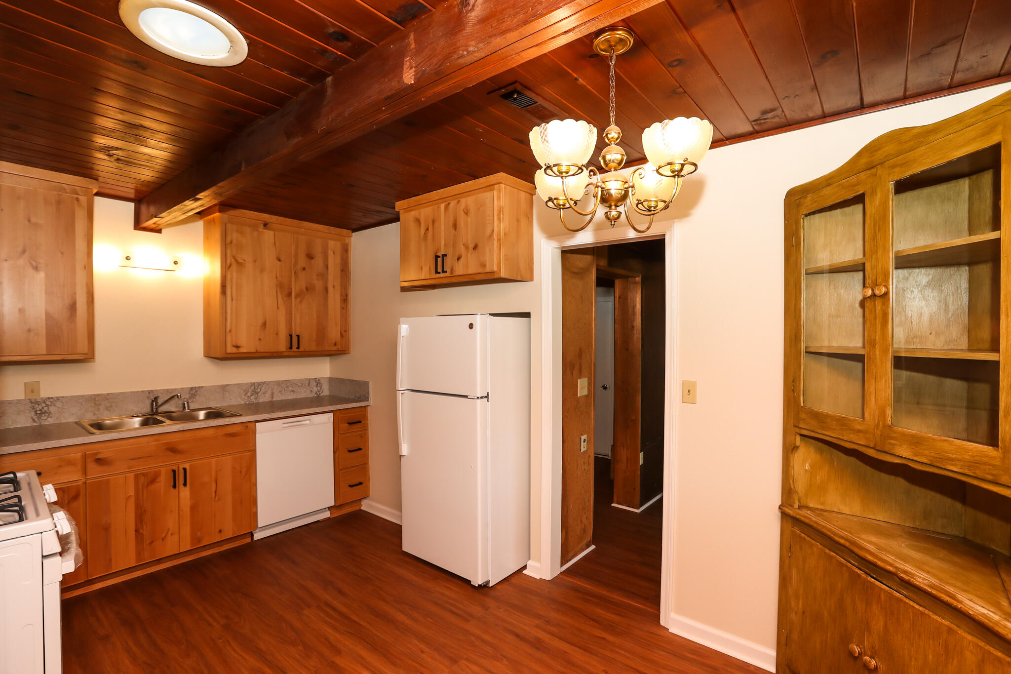 2867 Pinto Lane Anderson, CA 96007 - Photo 17 of 35 a kitchen with stainless steel appliances granite countertop a refrigerator a sink dishwasher and a dining table with wooden floor