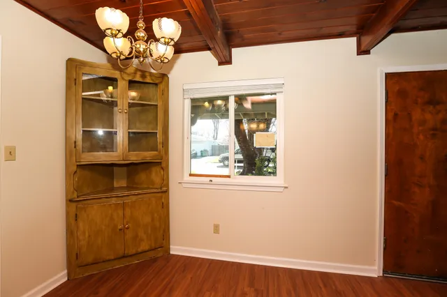 a view of a room with wooden floor and chandelier