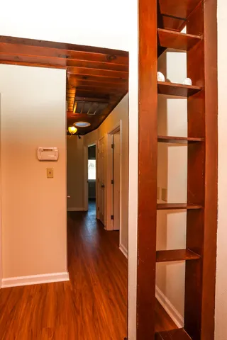 a view of a hallway with wooden floor and entryway