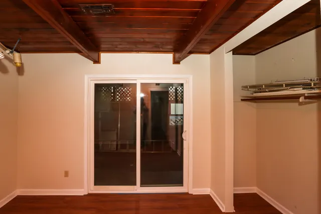 a view of a door and wooden floor