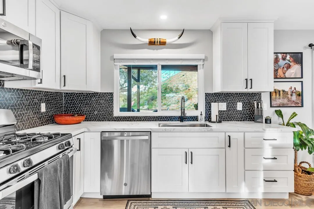 2608 Buenos Tiempos Fallbrook, CA 92028 - Photo 12 of 31 a kitchen with granite countertop a stove and a sink