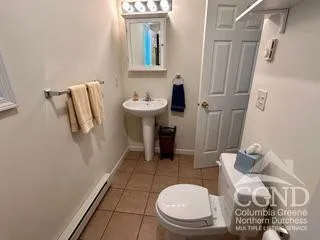 a bathroom with a sink toilet and mirror