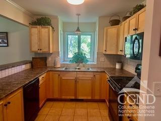 274 Route 65 Route, Unit 41 Hensonville, NY 12439 - Photo 8 of 28 a kitchen with a sink a stove and cabinets