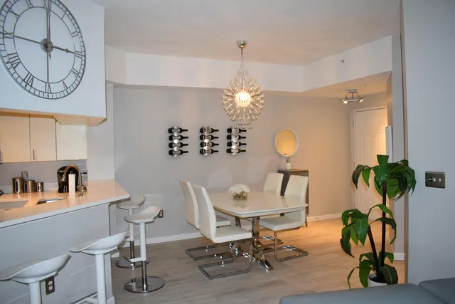a view of a room with gym equipment and a chandelier