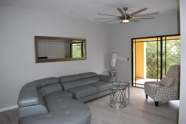 a living room with furniture and a large window