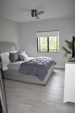 a bedroom with a large bed and a flat screen tv