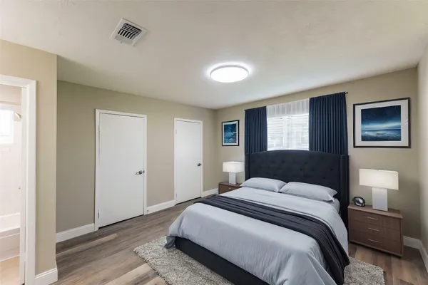 a bedroom with a bed and a potted plant