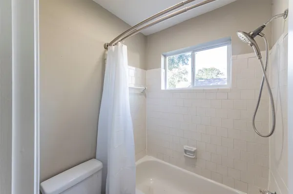 a bathroom with a bath tub and a shower