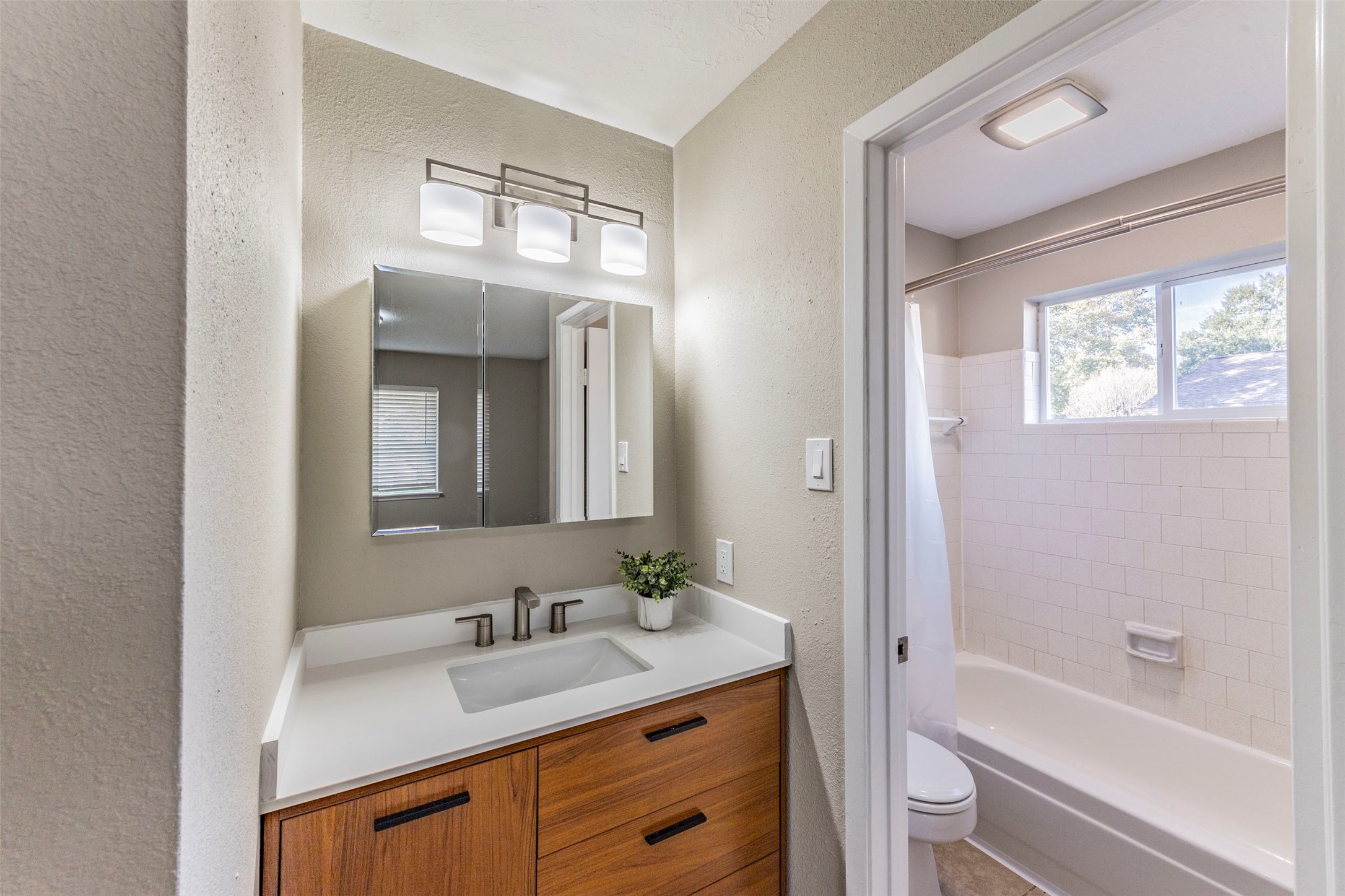 21022 Waymare Lane Spring, TX 77388 - Photo 17 of 29 a bathroom with a bathtub shower sink double vanity and a mirror