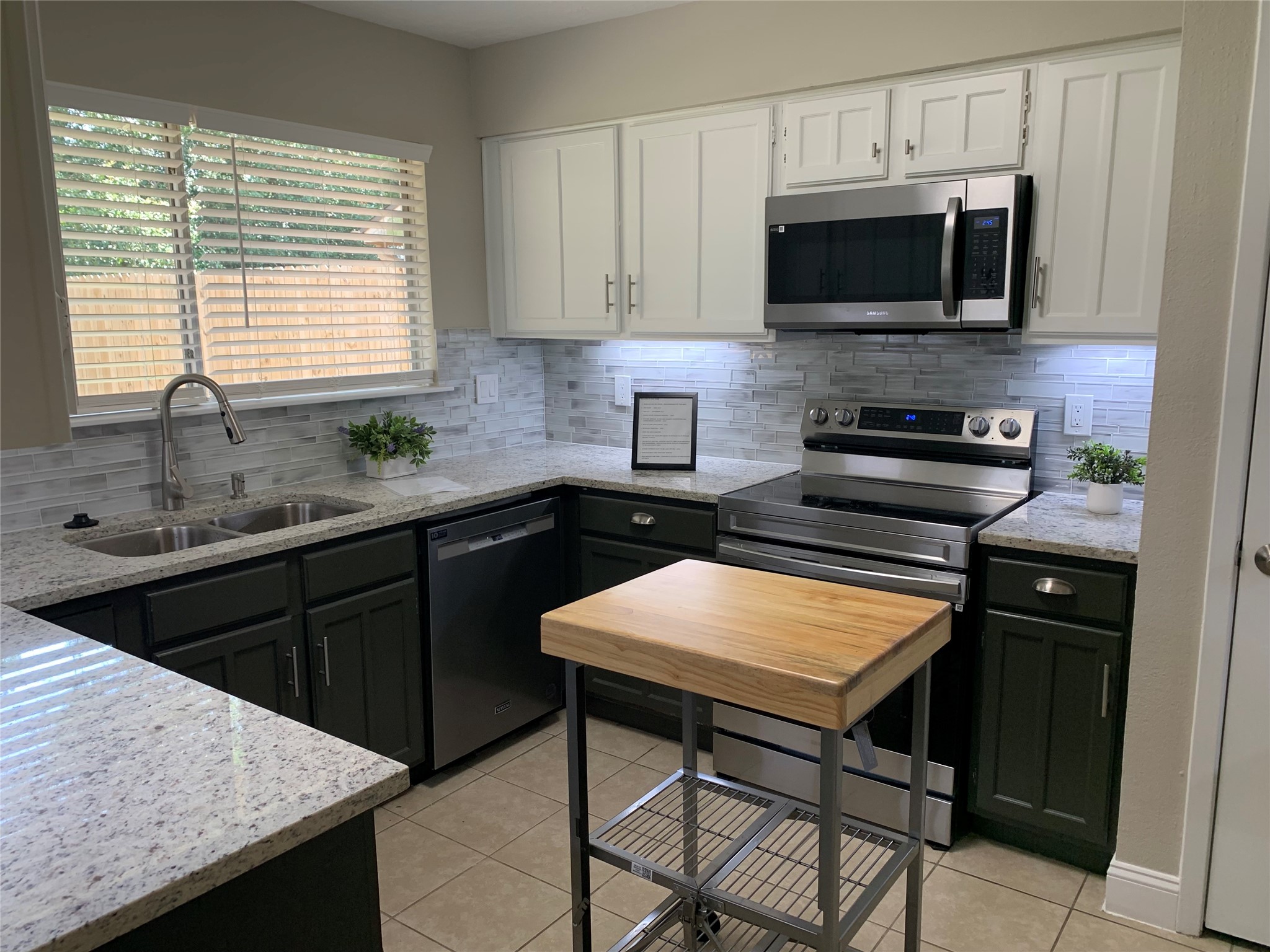 21022 Waymare Lane Spring, TX 77388 - Photo 8 of 29 a kitchen with a sink a microwave a stove and refrigerator