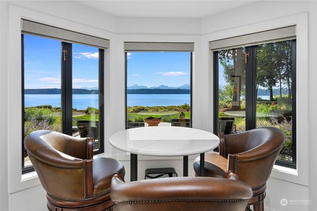 a view of a patio with chairs and plants