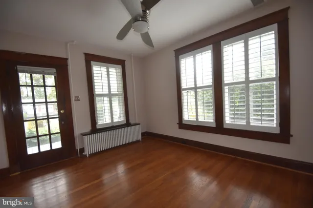 a view of a room with wooden floor and furniture