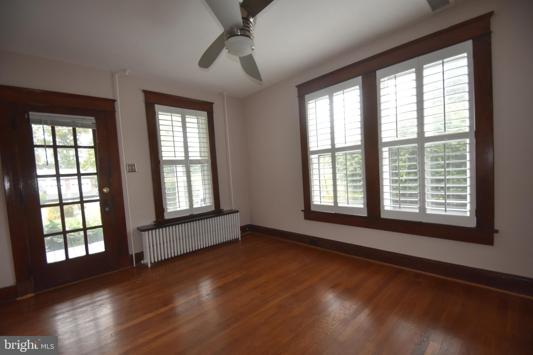 5619 A Jefferson Pike Frederick, MD 21703 - Photo 15 of 57 a view of an empty room with wooden floor and a window