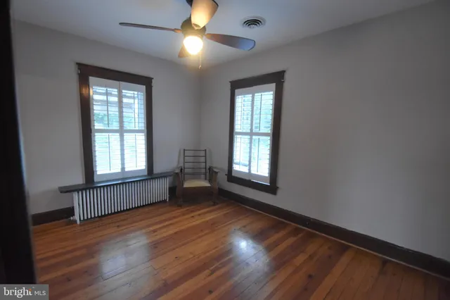 a view of a room with wooden floor and chandelier