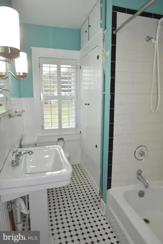 a view of a room with wooden floor and windows
