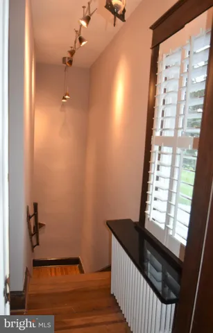 an empty room with wooden floor and a window