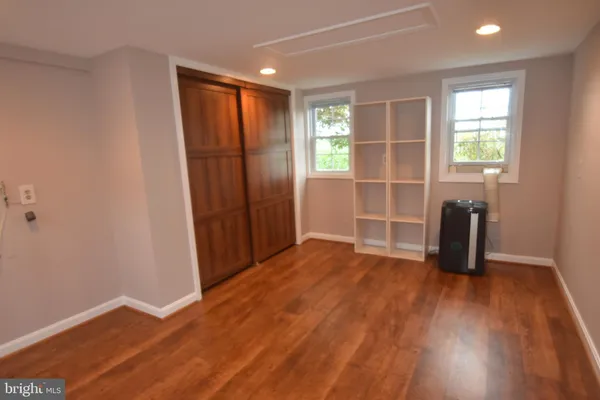 a front view of a house with a yard and potted plants