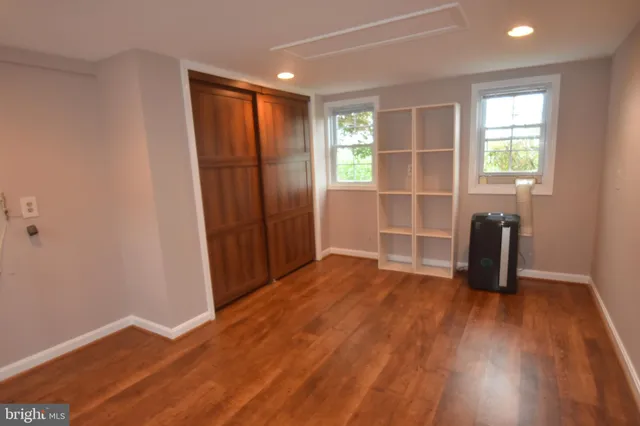 a front view of a house with a yard and potted plants