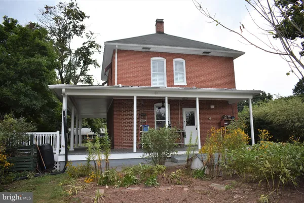 a view of a patio with table and chairs with wooden fence and plants