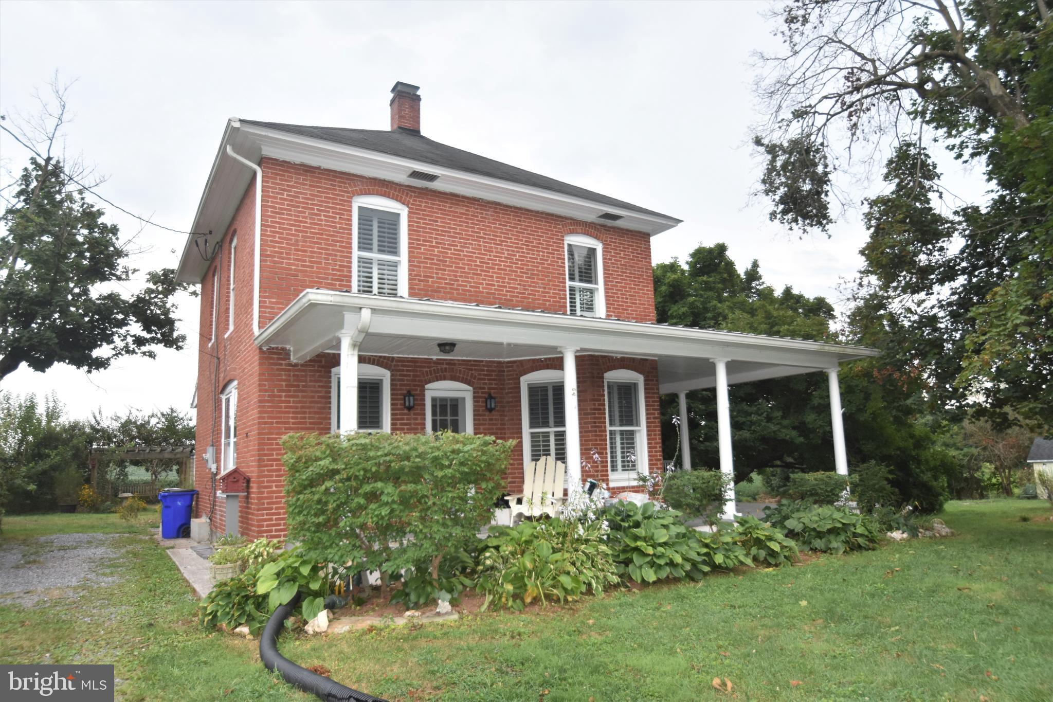 5619 A Jefferson Pike Frederick, MD 21703 - Photo 51 of 57 a front view of a house with a yard and potted plants