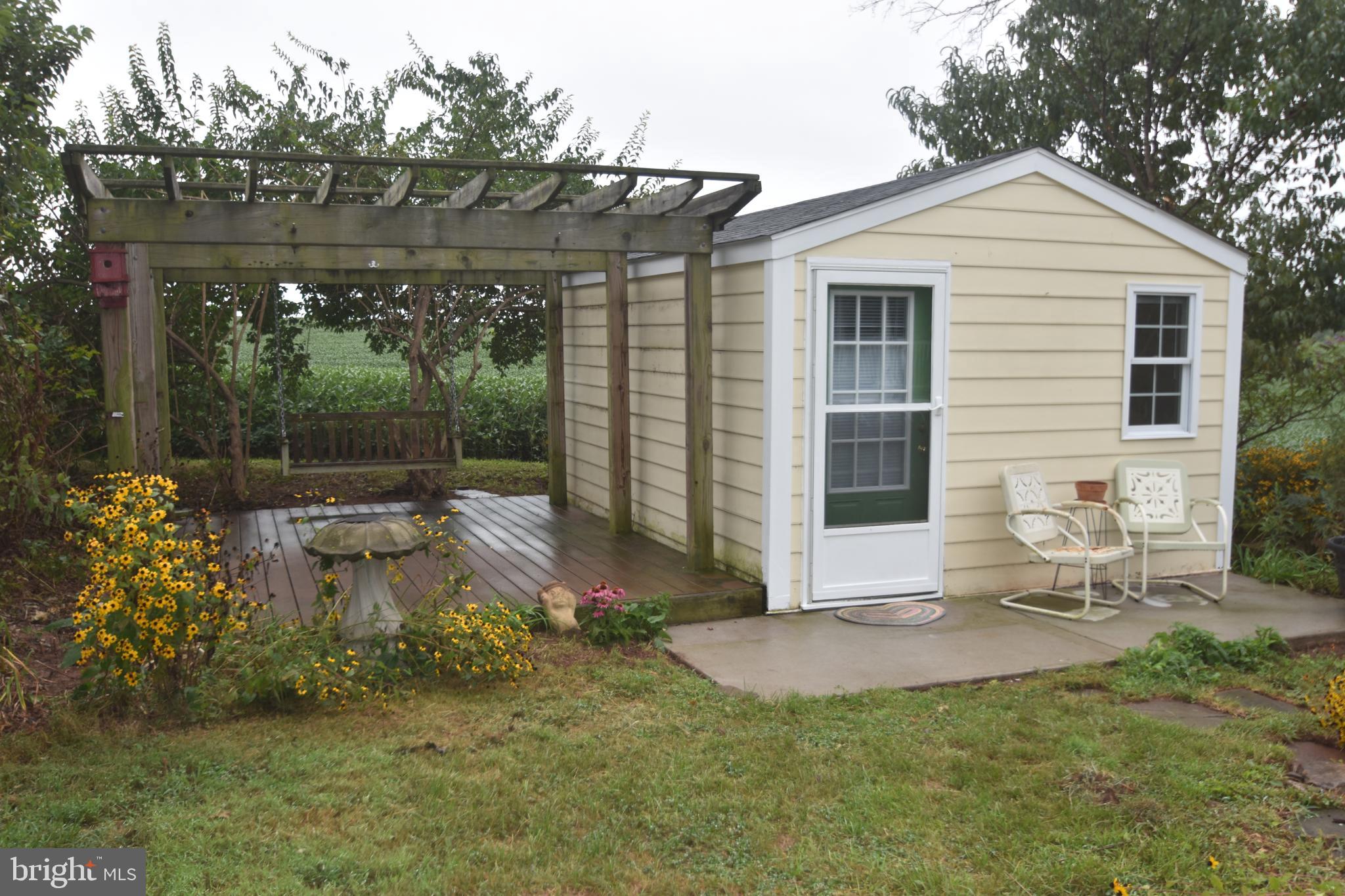 5619 A Jefferson Pike Frederick, MD 21703 - Photo 57 of 57 a view of a patio with table and chairs with wooden fence and plants