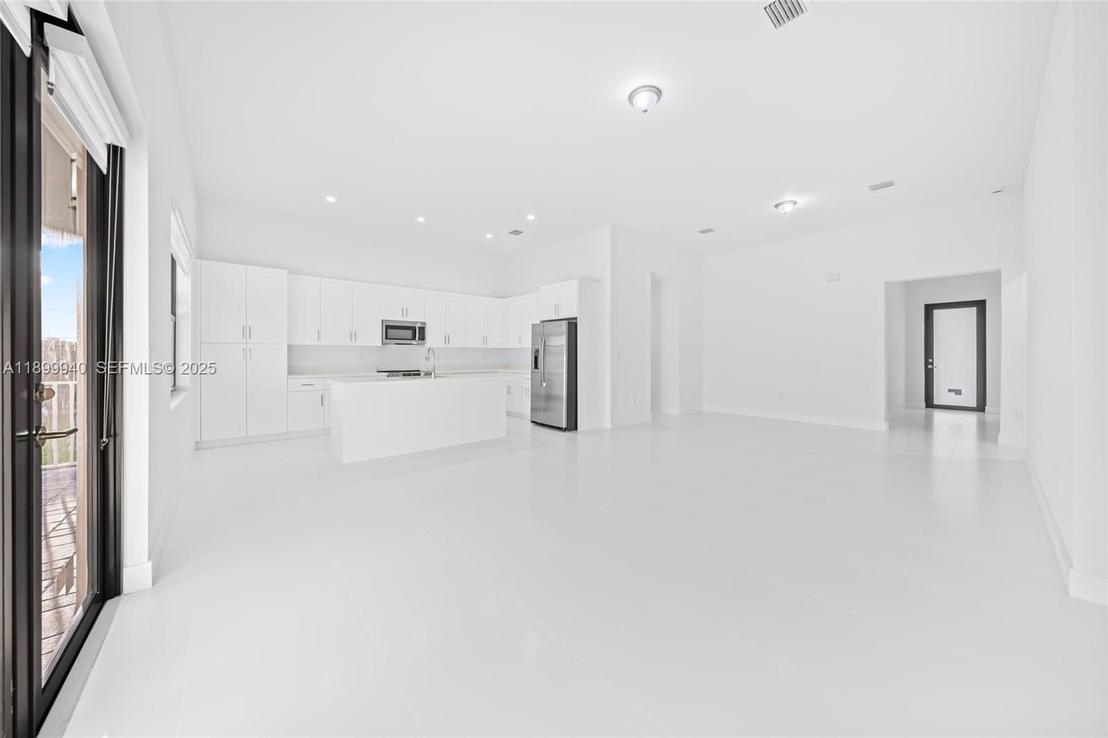 19504 Southwest 324th Street Homestead, FL 33030 - Photo 11 of 46 Great Room (view of dining, living, kitchen, door to 1/2 bath and laundry)