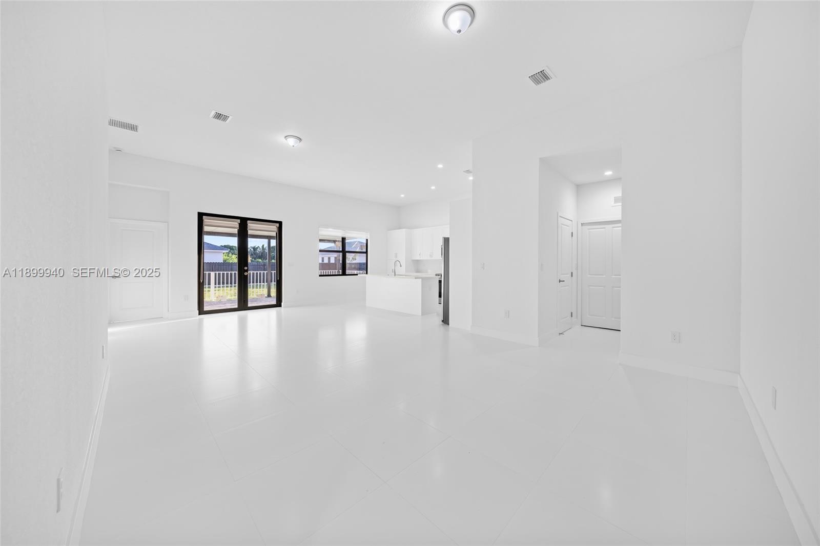 19504 Southwest 324th Street Homestead, FL 33030 - Photo 9 of 46 Great Room (view of dining, living, kitchen, door to 1/2 bath and laundry)