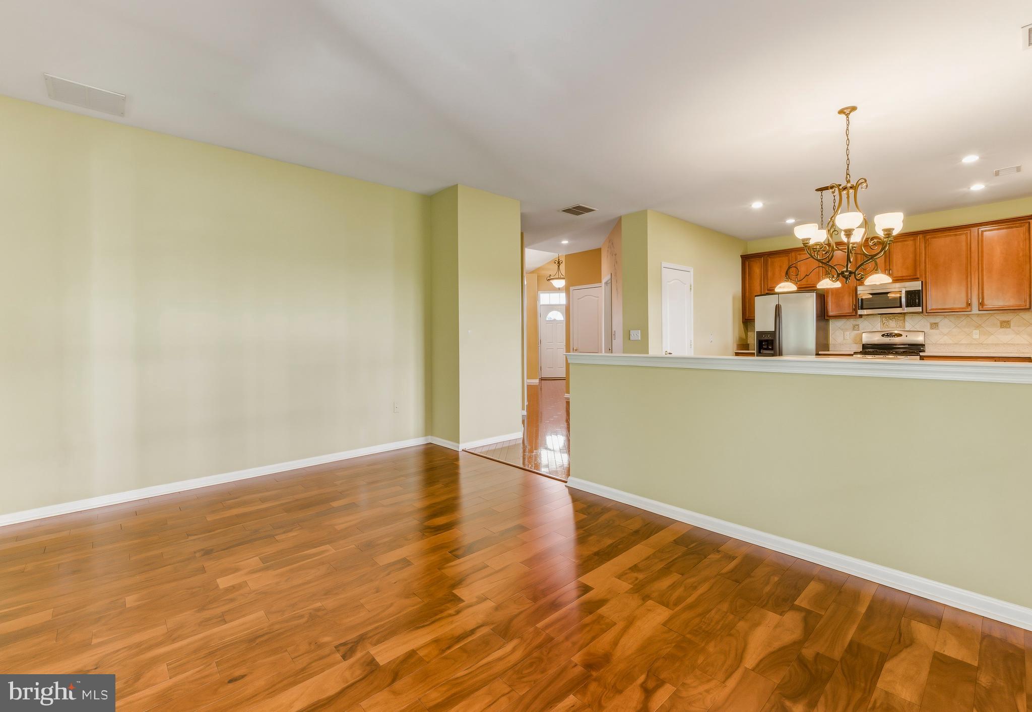 106 York Road West Deptford, NJ 08086 - Photo 16 of 31 an empty room with a kitchen view and wooden floor