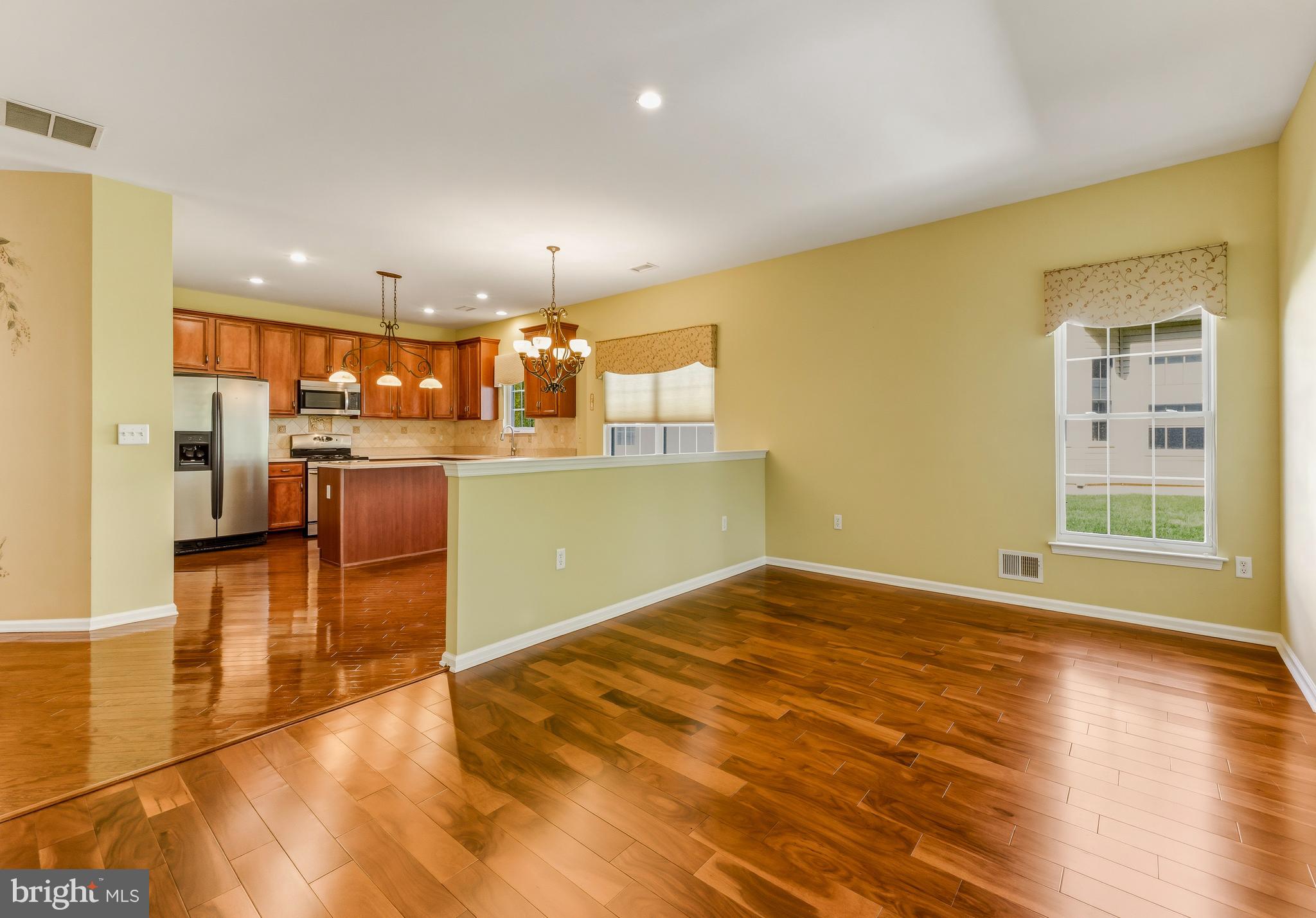 106 York Road West Deptford, NJ 08086 - Photo 17 of 31 a view of a kitchen with kitchen island a window wooden floor and stainless steel appliances