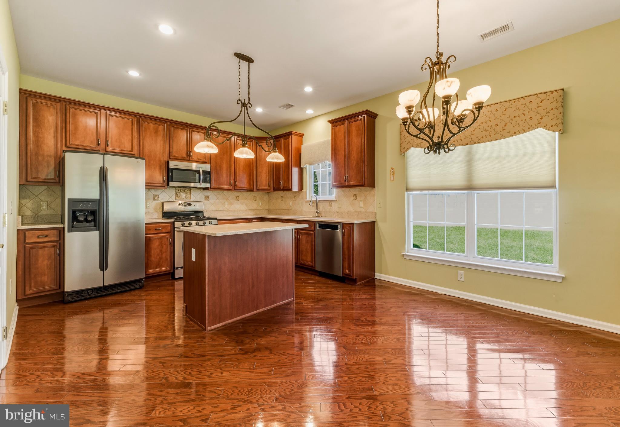 106 York Road West Deptford, NJ 08086 - Photo 10 of 31 a kitchen with stainless steel appliances granite countertop a refrigerator a sink dishwasher a stove and white cabinets with wooden floor